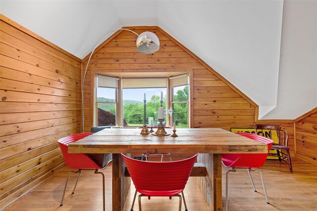 281 Hubert Rd, Jeffersonville, NY 12748 - dining room with wooden walls, vaulted ceiling, and light wood-type flooring