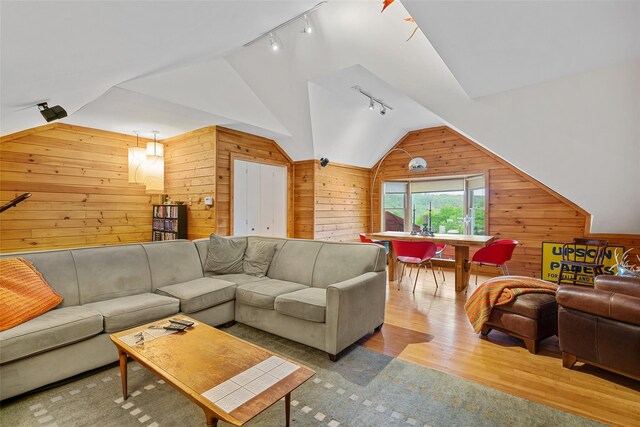 281 Hubert Rd, Jeffersonville, NY 12748 - living area with track lighting, wooden walls, vaulted ceiling, and wood finished floors