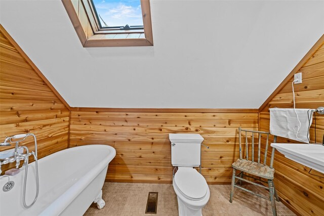 281 Hubert Rd, Jeffersonville, NY 12748 - full bath featuring a skylight, a freestanding bath, vanity, and toilet