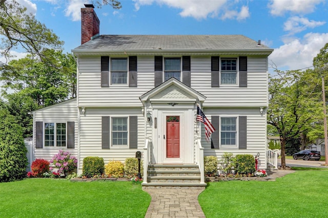 170 Little E Neck Rd S, Babylon, NY 11702 - view of front of home with a chimney and a front lawn