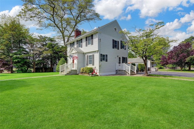 170 Little E Neck Rd S, Babylon, NY 11702 - view of side of home with a chimney and a lawn
