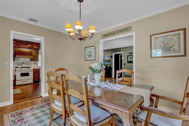 170 Little E Neck Rd S, Babylon, NY 11702 - dining area featuring a chandelier, wood finished floors, crown molding, and baseboards