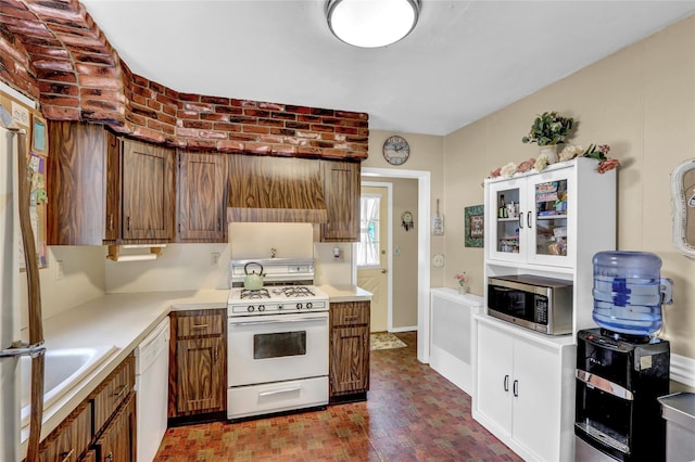 170 Little E Neck Rd S, Babylon, NY 11702 - kitchen featuring white appliances, light countertops, brick patterned flooring, and brown cabinetry