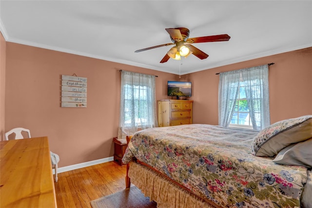 170 Little E Neck Rd S, Babylon, NY 11702 - bedroom featuring multiple windows, light wood finished floors, baseboards, ornamental molding, and a ceiling fan