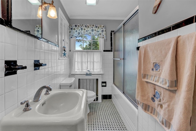 170 Little E Neck Rd S, Babylon, NY 11702 - full bathroom featuring tile walls, toilet, radiator, tile patterned floors, and a sink