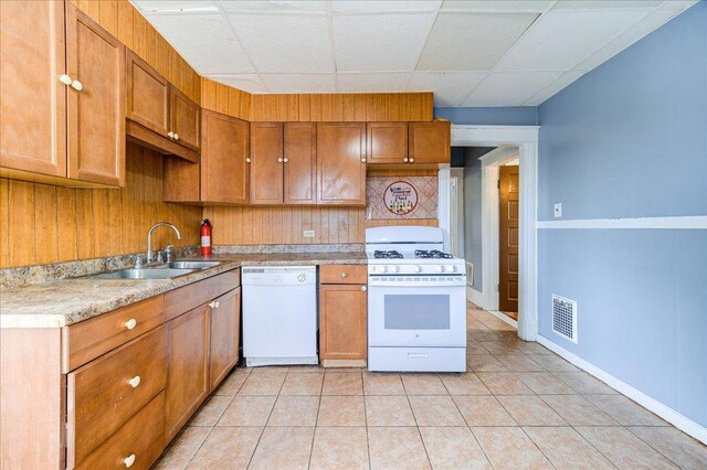 5 Gray Sts, Poughkeepsie, NY 12601 - kitchen featuring white appliances, a sink, brown cabinetry, light countertops, and light tile patterned flooring