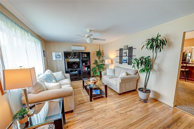 964 Manor Ln, Bay Shore, NY 11706 - living area featuring an AC wall unit, light wood-style floors, ceiling fan, and baseboards