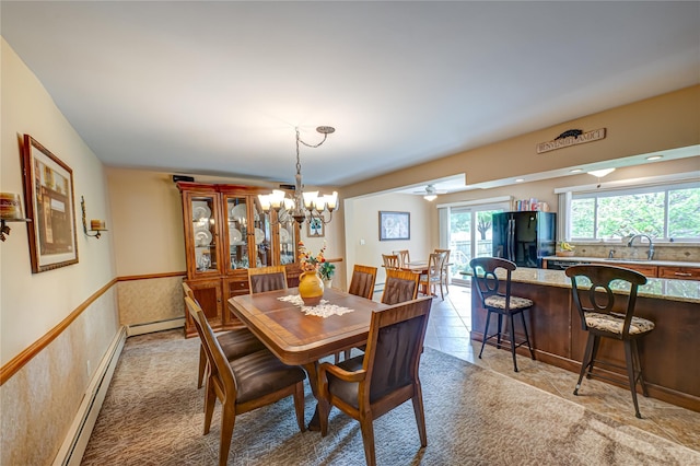 964 Manor Ln, Bay Shore, NY 11706 - dining room featuring a chandelier, a baseboard radiator, light colored carpet, and a wainscoted wall