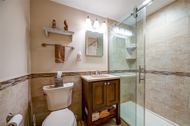 964 Manor Ln, Bay Shore, NY 11706 - bathroom featuring toilet, tile walls, vanity, wainscoting, and combined bath / shower with glass door