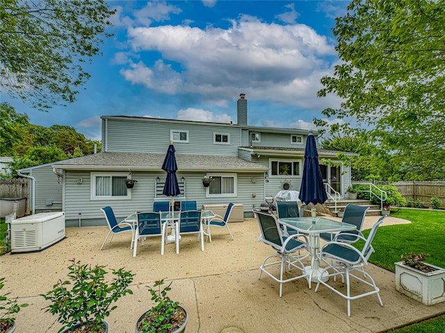 964 Manor Ln, Bay Shore, NY 11706 - back of property featuring outdoor dining space, a patio area, and a chimney