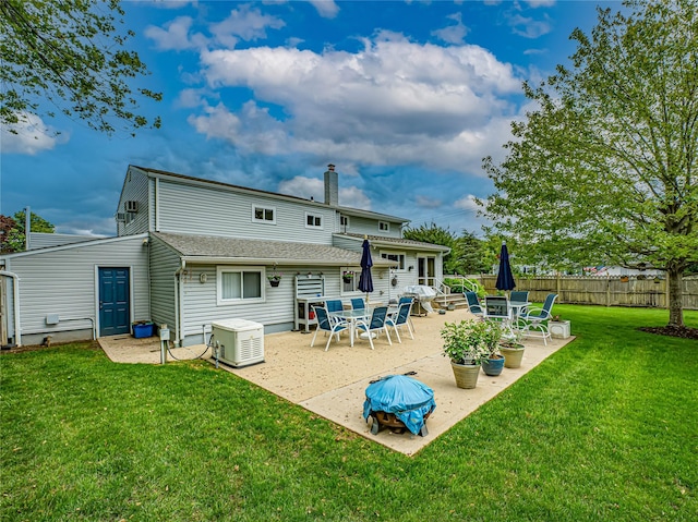 964 Manor Ln, Bay Shore, NY 11706 - rear view of house featuring a patio, a chimney, and a cooling unit
