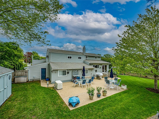964 Manor Ln, Bay Shore, NY 11706 - back of property with a chimney, a shingled roof, and a patio
