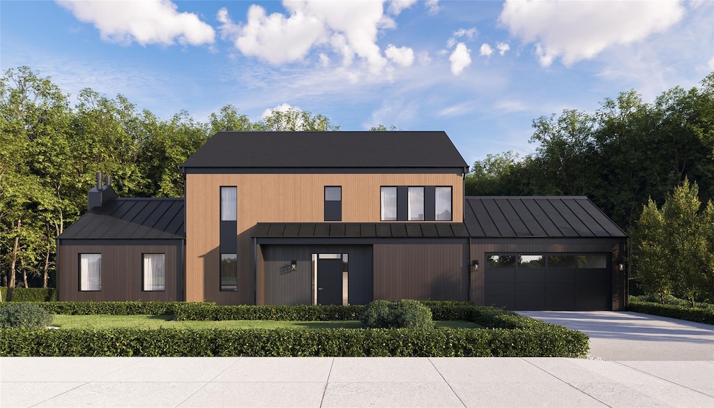 24 Wildwood Dr, Rock Tavern, NY 12575 - view of front of house with a standing seam roof, metal roof, an attached garage, and driveway