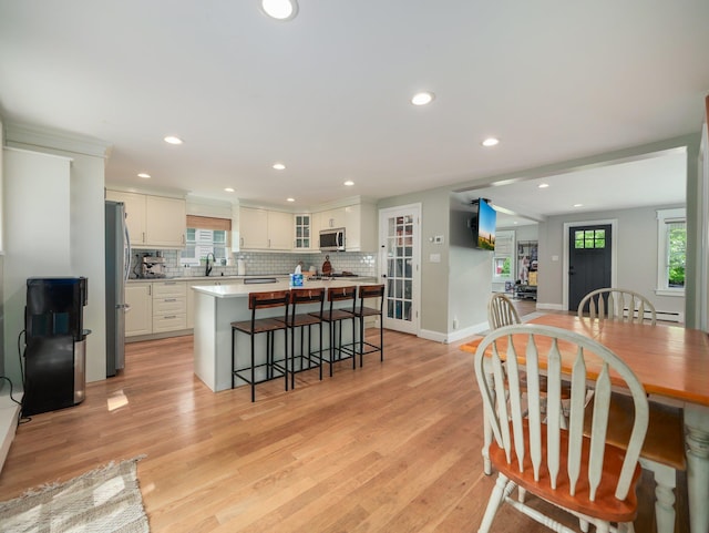 29 Chestnut St, Pearl River, NY 10965 - kitchen with stainless steel appliances, a kitchen breakfast bar, tasteful backsplash, recessed lighting, and a kitchen island