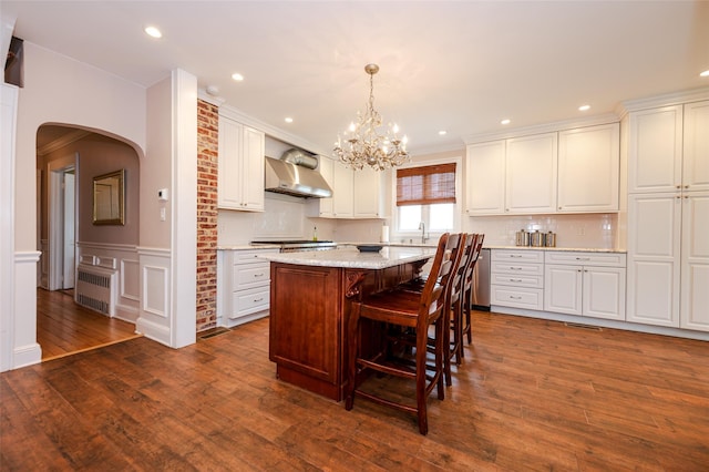 70 Loines Ave, Merrick, NY 11566 - kitchen with radiator, arched walkways, dark wood-style floors, white cabinetry, and a chandelier
