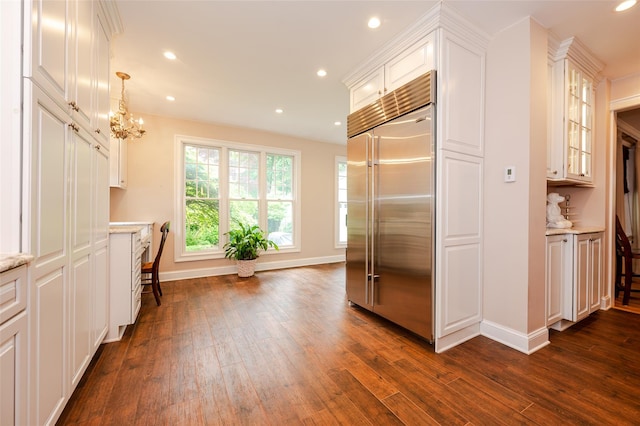 70 Loines Ave, Merrick, NY 11566 - kitchen featuring stainless steel built in refrigerator, baseboards, dark wood finished floors, white cabinetry, and recessed lighting