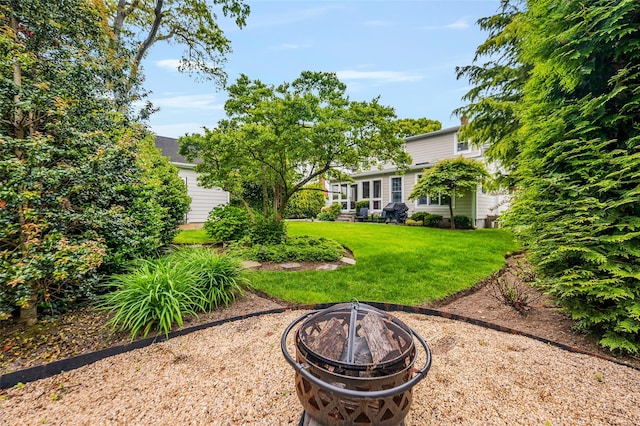 70 Loines Ave, Merrick, NY 11566 - view of green lawn featuring a fire pit