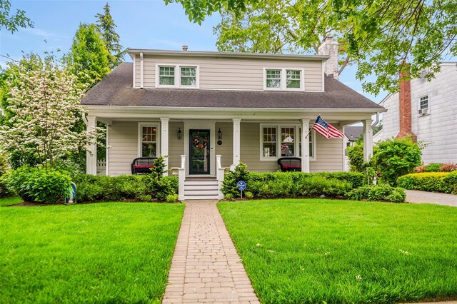 70 Loines Ave, Merrick, NY 11566 - bungalow-style house with covered porch, a front yard, a chimney, and a shingled roof