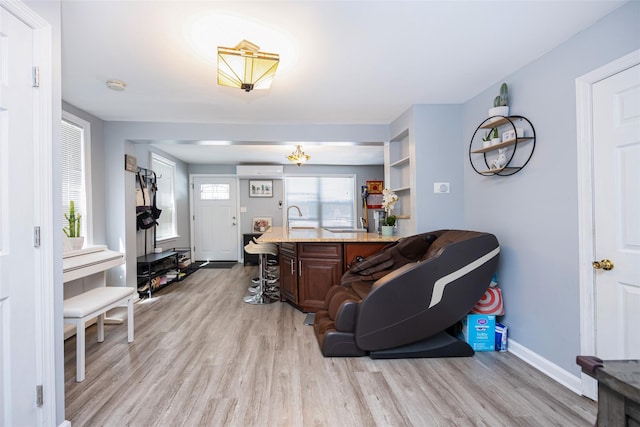 2226 124th St, College Point, NY 11356 - living room with light wood-style floors, a wall mounted AC, and baseboards