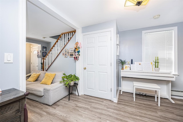 2226 124th St, College Point, NY 11356 - entrance foyer with stairs, light wood-style flooring, baseboards, and a baseboard heating unit