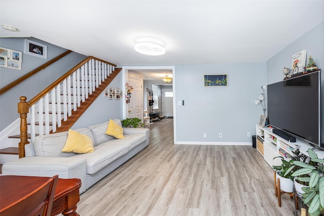 2226 124th St, College Point, NY 11356 - living room with stairway, light wood-type flooring, and baseboards