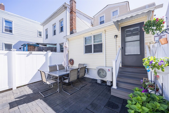 2226 124th St, College Point, NY 11356 - view of patio with a cooling unit, entry steps, and outdoor dining area