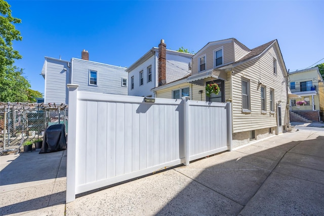 2226 124th St, College Point, NY 11356 - rear view of property with a chimney