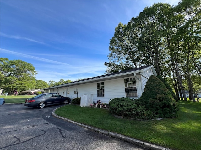411A Weymouth Ct Unit 411A, Ridge, NY 11961 - view of property exterior featuring a yard