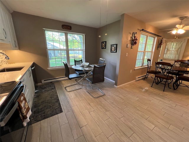 411A Weymouth Ct Unit 411A, Ridge, NY 11961 - dining room featuring light wood-style floors, plenty of natural light, baseboards, and a baseboard heating unit