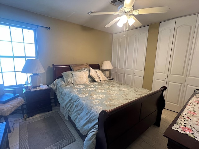 411A Weymouth Ct Unit 411A, Ridge, NY 11961 - bedroom with multiple closets, wood finished floors, and ceiling fan