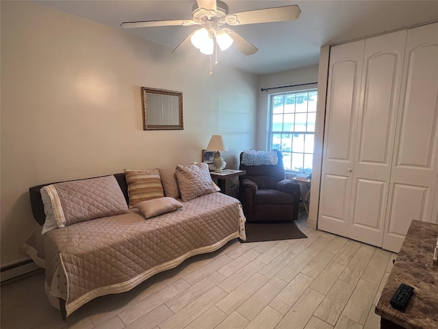 411A Weymouth Ct Unit 411A, Ridge, NY 11961 - living room featuring light wood-style flooring, a ceiling fan, and baseboard heating