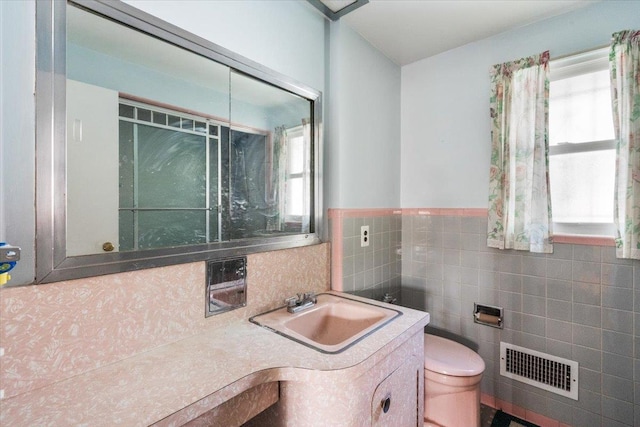 26-03 157th St, Flushing, NY 11354 - bathroom featuring vanity, toilet, tile walls, and a wainscoted wall