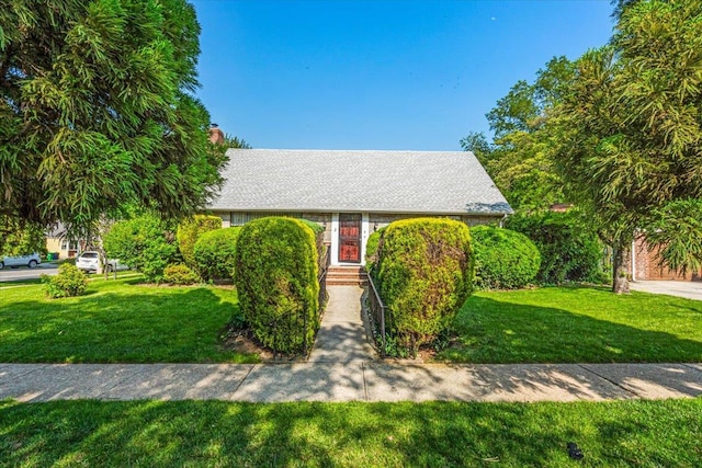 26-03 157th St, Flushing, NY 11354 - view of front of home with a front lawn and a chimney