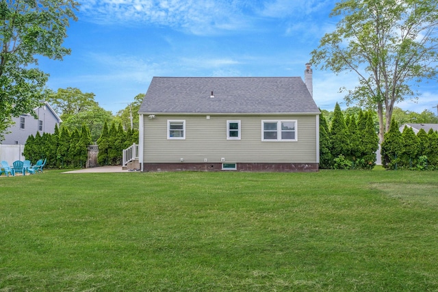 2251 Ocean Ave, Ronkonkoma, NY 11779 - back of property with a lawn, a chimney, a patio area, and roof with shingles