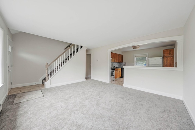 2251 Ocean Ave, Ronkonkoma, NY 11779 - unfurnished living room with stairway, light colored carpet, and baseboards
