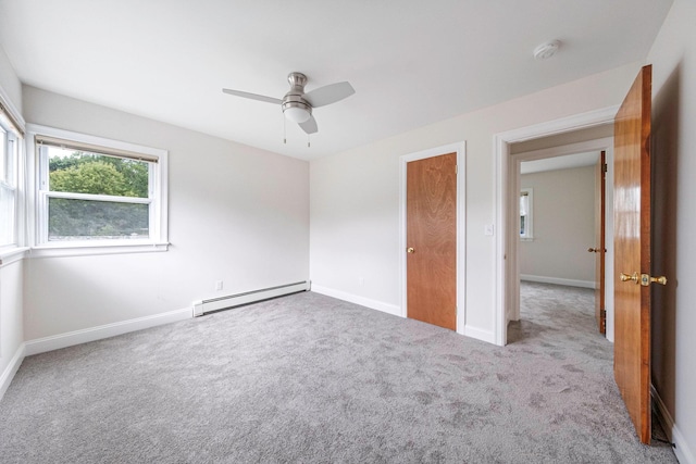 2251 Ocean Ave, Ronkonkoma, NY 11779 - unfurnished bedroom with baseboard heating, carpet flooring, baseboards, and a ceiling fan