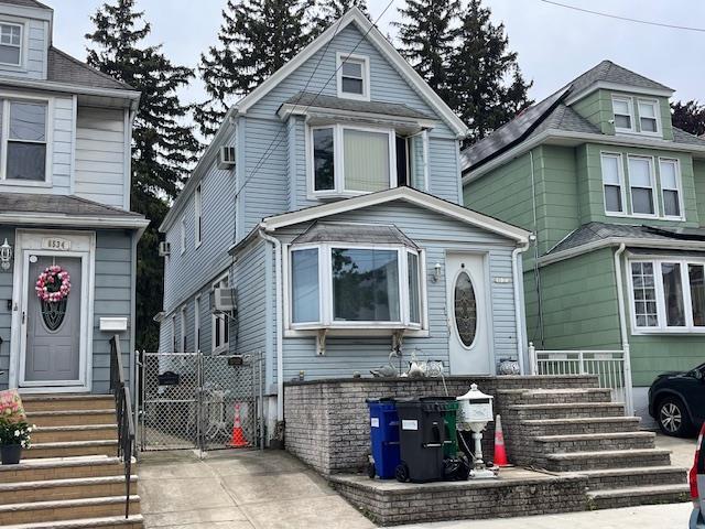 65-32 80th Ave, Glendale, NY 11385 - american foursquare style home featuring entry steps and a gate