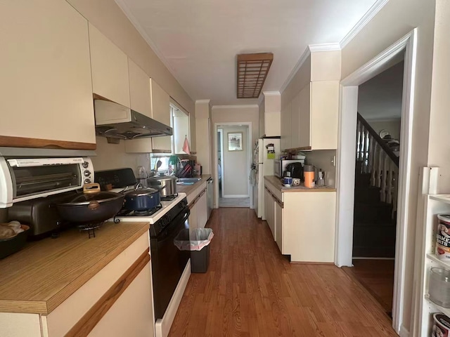 58-36 Bell Blvd, Bayside, NY 11364 - kitchen featuring extractor fan, range with gas cooktop, light countertops, white cabinets, and wood finished floors