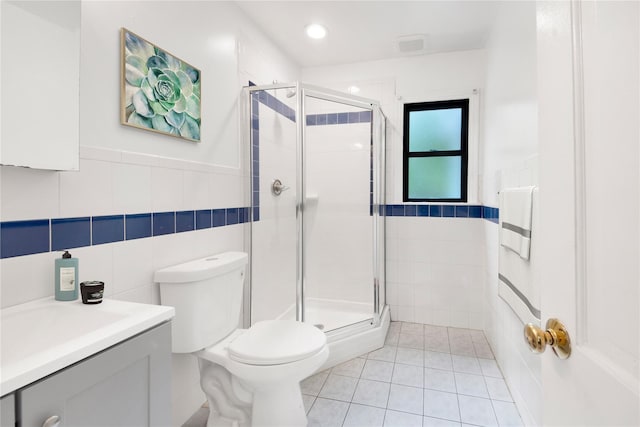 64 Lincoln Rd, Putnam Valley, NY 10579 - bathroom with tile walls, vanity, toilet, a shower stall, and tile patterned flooring