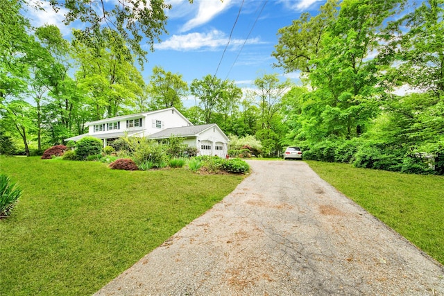 64 Lincoln Rd, Putnam Valley, NY 10579 - view of front of house featuring driveway, a front lawn, and an attached garage