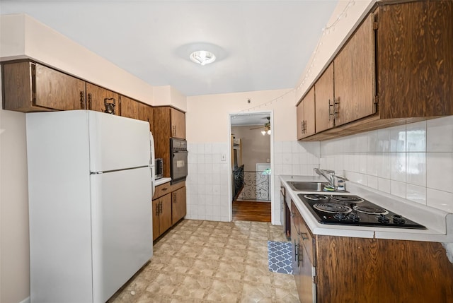 8 Ridge Rd, Wheatley Heights, NY 11798 - kitchen with black appliances, a sink, ceiling fan, tile walls, and light countertops