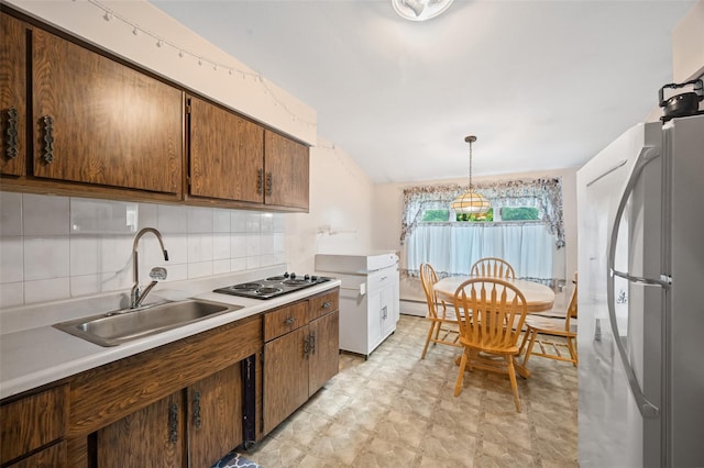 8 Ridge Rd, Wheatley Heights, NY 11798 - kitchen featuring freestanding refrigerator, black electric stovetop, a sink, light floors, and tasteful backsplash