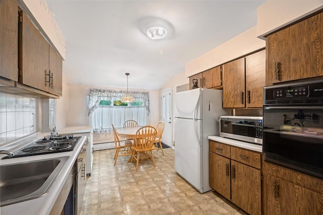 8 Ridge Rd, Wheatley Heights, NY 11798 - kitchen with black appliances, a sink, light countertops, baseboard heating, and vaulted ceiling