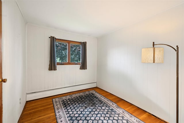 8 Ridge Rd, Wheatley Heights, NY 11798 - unfurnished room featuring baseboard heating and wood finished floors