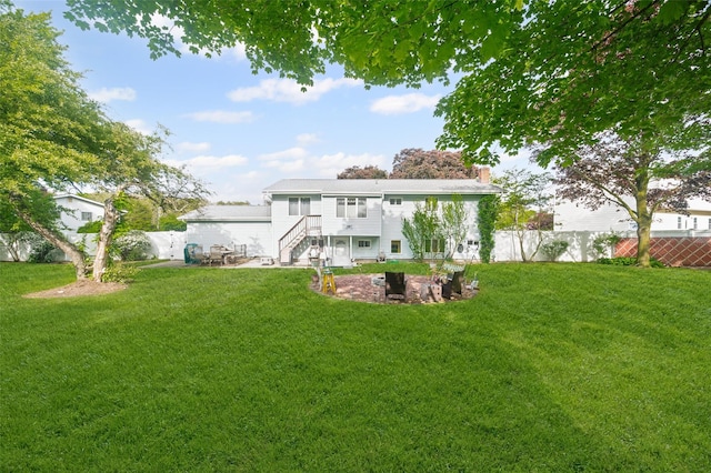 8 Ridge Rd, Wheatley Heights, NY 11798 - rear view of house with a chimney, a patio area, and a fire pit