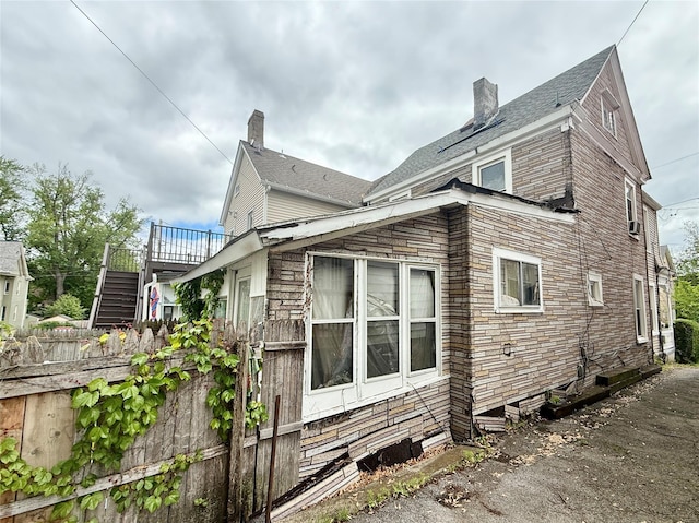 37 Liberty St, Newburgh, NY 12550 - view of side of property with stairway, a chimney, and a deck