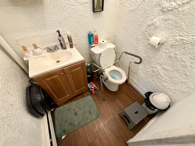 37 Liberty St, Newburgh, NY 12550 - bathroom featuring vanity, a textured wall, toilet, and wood finished floors