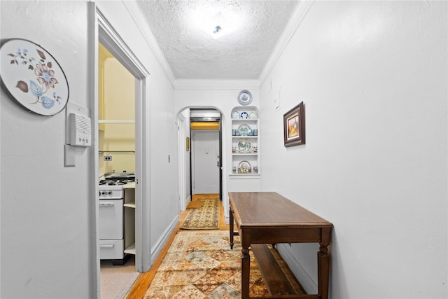 3000 Valentine Ave Unit 1D, Bronx, NY 10458 - hallway with a textured ceiling, built in features, crown molding, and arched walkways