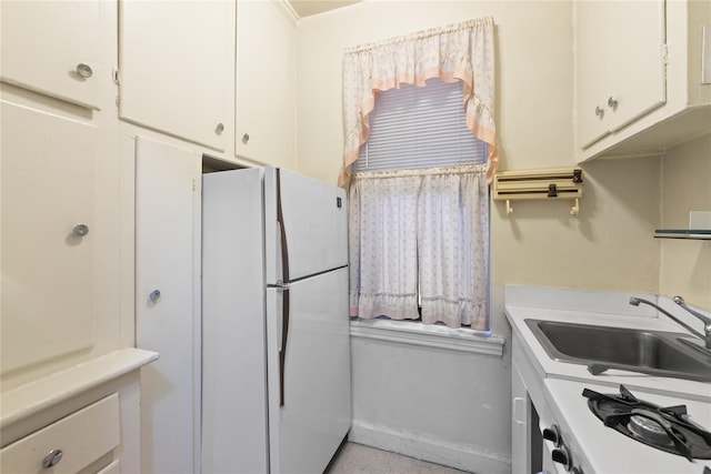 3000 Valentine Ave Unit 1D, Bronx, NY 10458 - kitchen featuring freestanding refrigerator, a sink, light countertops, and white cabinetry