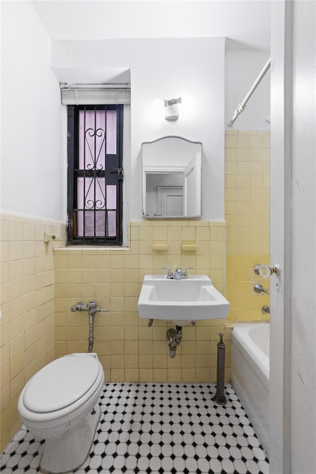 3000 Valentine Ave Unit 1D, Bronx, NY 10458 - bathroom featuring tile walls, tile patterned floors, a wainscoted wall, toilet, and shower / tub combination